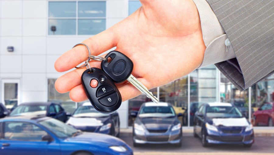 Hands with car keys. Dealer and client.